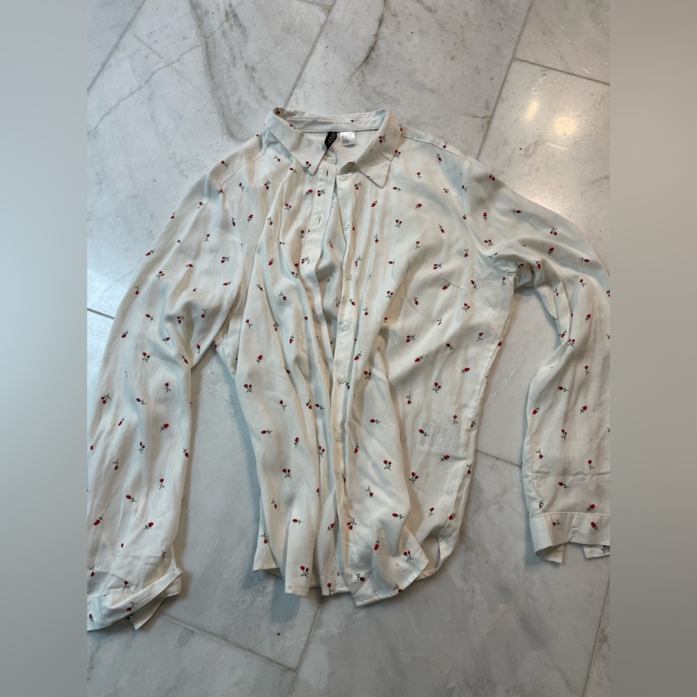 H and M, women’s size 6, white button down blouse w red flowers. Gently worn